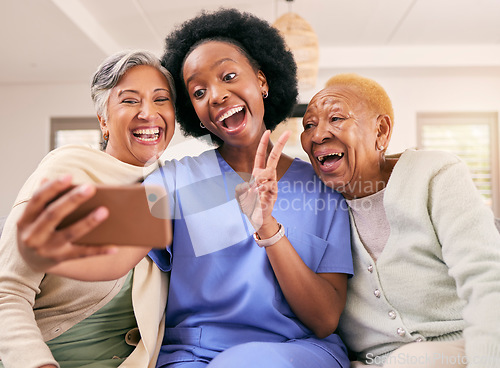 Image of Selfie, caregiver and senior women with peace sign for social media, online post or profile picture on sofa. Retirement, nursing home and nurse with elderly people take photo for happy memories