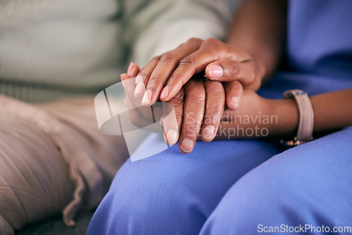 Image of Nurse, holding hands and elderly support in a retirement and nursing home with care. Healthcare, nursing and medical professional with a patient showing empathy, kindness and compassion at doctor job