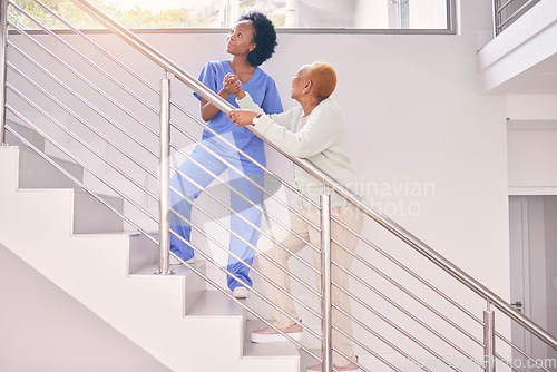 Image of Stairs, nurse and help senior woman, holding hands and assistance in home together. Caregiver, steps and elderly African patient walking, support of person with a disability or kindness in healthcare