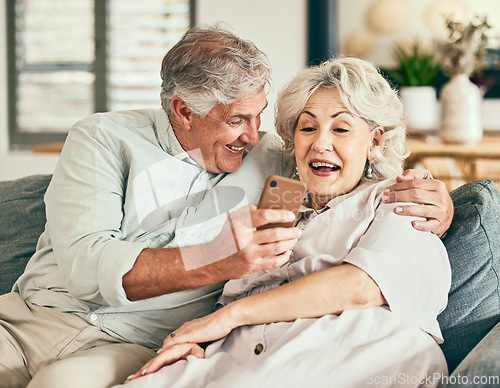 Image of Relax, phone and funny with old couple on sofa for streaming, social media and communication. Excited, internet and website with senior man and woman laughing in living room at home for news and app