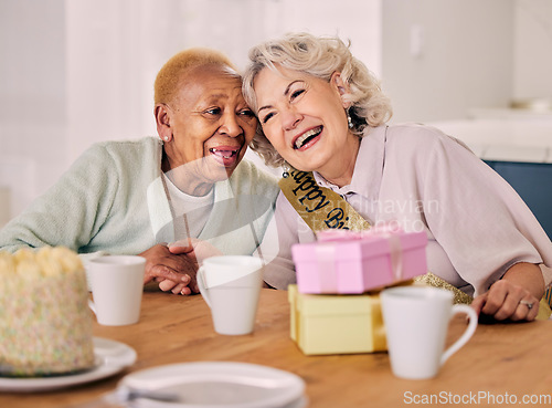 Image of Senior women, birthday celebration and party event at a home with a present and friends gift. Surprise, happy singing and retirement of elderly people at a dining room table together with a smile