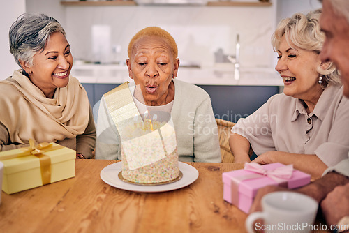 Image of Senior women, friends and candles on birthday cake for a celebration, party and social gathering. Elderly people together at table to celebrate and blow flame at retirement home event with happiness