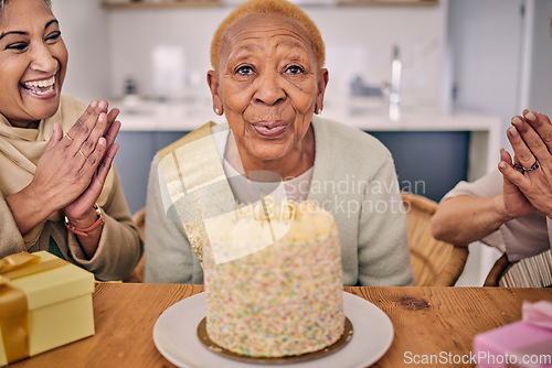 Image of Senior woman, blowing candle and cake portrait at a birthday party or event with clapping and excited. Elderly friends, smile and laughing in retirement and nursing home with celebration and fun