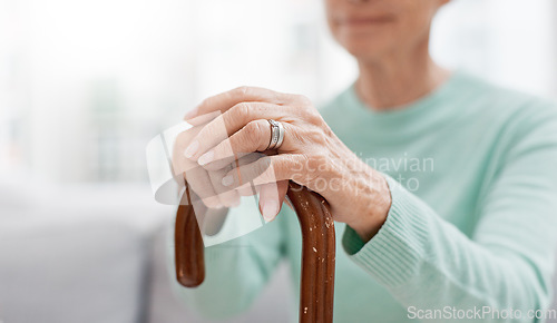 Image of Hands, walking stick and elderly woman with walking stick on a sofa for balance, support and mobility. Walk, aid and old female at senior care facility with disability, dementia or chronic arthritis