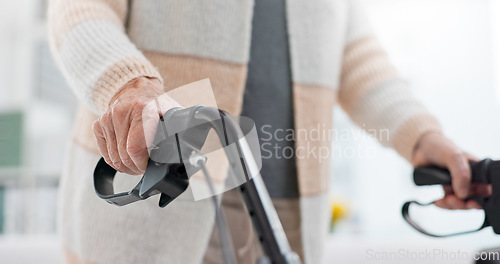 Image of Hands, walking aid and a senior person with a disability in recover or rehabilitation in a clinic for mobility. Healthcare, medical and physiotherapy with an elderly patient in a nursing home