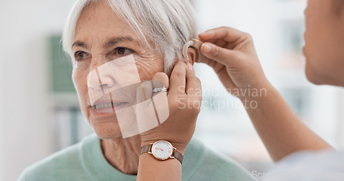 Image of Old woman, doctor hands and patient with hearing aid, help and support with healthcare in clinic. Person with disability, deaf and people, trust and communication, health insurance and medical