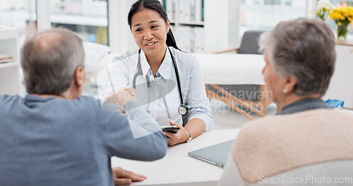 Image of Doctor consultation meeting, elderly couple and handshake for thank you, welcome and agreement for hospital insurance. Healthcare clinic, senior people and cardiology worker shaking hands for goodbye