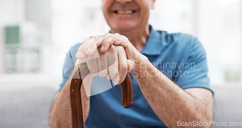 Image of Walking stick, hands and happy elderly man with wooden cane on sofa for balance, support and mobility. Walk, aid and old male at senior care facility with disability, dementia or chronic arthritis