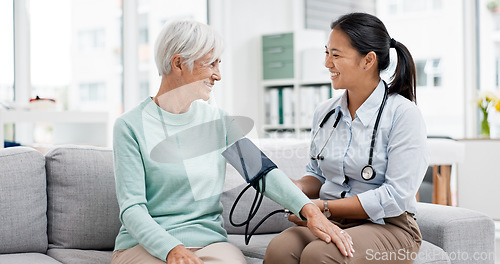 Image of Doctor, senior patient and blood pressure check with consultation, talking and help, health in hospital office. Women at clinic, communication and cardiovascular healthcare, elderly care and support