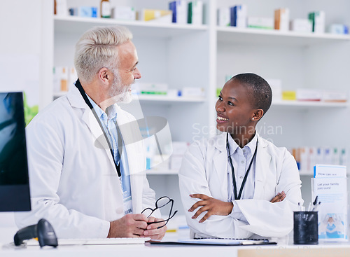 Image of Discussion, team and pharmacists with medication in pharmacy for healthcare or medical career. Conversation, medicine and senior chemist mentor talking to female pharmaceutical student by dispensary.