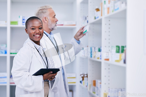 Image of Tablet, portrait and pharmacists checking medication for inventory, stock or medical research. Healthcare, medicine and senior chemist mentor teaching female pharmaceutical student with technology.