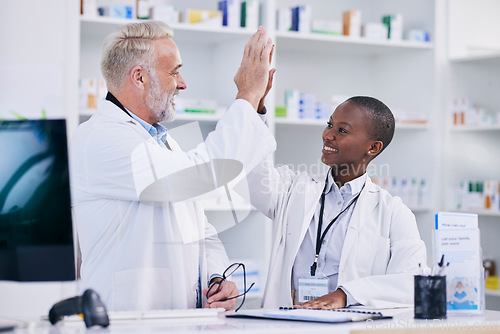 Image of Pharmacy, high five and teamwork with people in store for medical, success or motivation. Medicine, healthcare and support with man and woman in pills dispensary for community, mentorship or learning