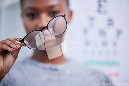 Image of Optometry, eyesight and black woman with glasses for vision, eye care and optical health in clinic. Healthcare, optometrist and person with prescription lens, frames and spectacles for testing eyes