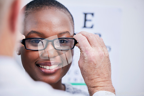 Image of Smile, optometry and a black woman with glasses and a doctor for consultation and eye care. Happy, clinic and an African girl with eyewear from an optometrist for support, test or service for vision