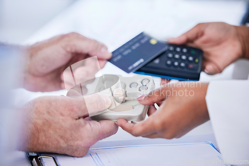 Image of Doctor, hands and patient with credit card in payment for hearing aid, sound or consultation at clinic. Closeup of person paying on pos or electronic machine for ear device in audiology at hospital