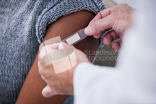 Image of Vaccine, plaster and doctor hands with patient for healthcare consultation, hospital first aid or medical support service. Pharmacy clinic nurse, closeup arm or pharmacist helping person with bandage