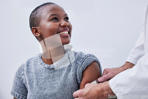 Image of Doctor hands, plaster and happy black woman, patient or client for HPV protection, hospital first aid or medical service. Pharmacy vaccine, arm wound or pharmacist helping African person with bandage