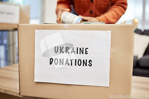 Image of Box, donation and charity to support Ukraine with empathy, kindness and love for human rights, food or gift. Person, volunteer and hands with product, cardboard package and care for war victims