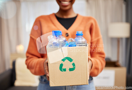 Image of Plastic, recycle and woman with bottle in box in living room for eco friendly, reusable and cleaning. Sustainability, conservation and happy person with container to reduce waste, litter and garbage