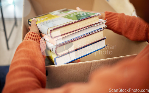 Image of Donation, charity and woman hands with books in box for nonprofit and cardboard container at home. Education textbook, donating and house with giveaway and spring cleaning for community support