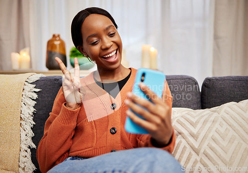 Image of Selfie, black woman and peace sign at home with a smile for social media, motivation and video call. Photo, happy and African female person in a living room with a v and emoji hand gesture at house