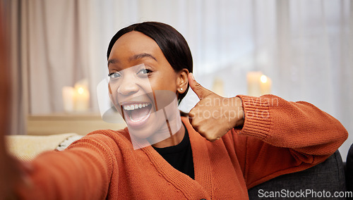 Image of Selfie, black woman and thumbs up at home with a smile for success, motivation and excited. Portrait, happy and African female person in a living room with a like, yes and emoji hand sign at house