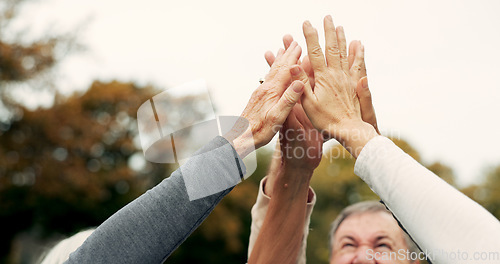 Image of High five, partnership and a group of senior friends together in a park for motivation, success or celebration. Team building, support and community with elderly people bonding outdoor in a garden