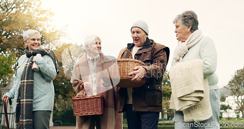 Image of Walking, picnic and senior friends in the park together for bonding or conversation during retirement. Smile, basket and a group of happy elderly people in a garden for freedom, fresh air to relax