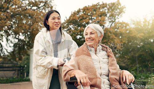 Image of Elderly woman, wheelchair and nurse in park, nature or garden outdoor. Happy, senior person with a disability and walking with caregiver for health, wellness and physical therapy for rehabilitation