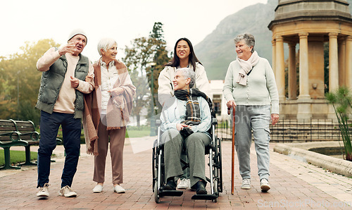 Image of Retirement, walking and elderly friends in park for bonding, wellness and quality time together outdoor. Wheelchair, health and senior man and women with caregiver for fresh air, nature and relax