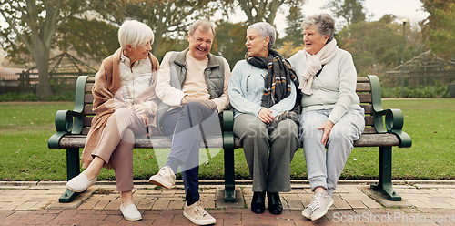 Image of Conversation, nature and mature friends in a park sitting on bench for fresh air together. Happy, smile and group of senior people in retirement in discussion or talking in an outdoor green garden.