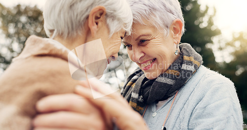 Image of Love, connection and senior women being affection for romance and bonding on an outdoor date. Nature, commitment and elderly female couple in retirement with intimate moment in a green garden or park