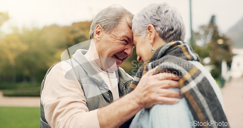 Image of Kiss, forehead and senior couple in a park with love, happy and conversation with romantic bonding. Kissing, old people and elderly man embrace woman with care, romance or soulmate connection outdoor