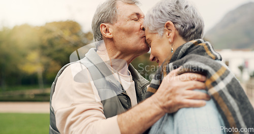 Image of Forehead, kiss and senior couple in a park with love, happy and conversation with romantic bonding. Kissing, old people and elderly man embrace woman with care, romance or soulmate connection outdoor