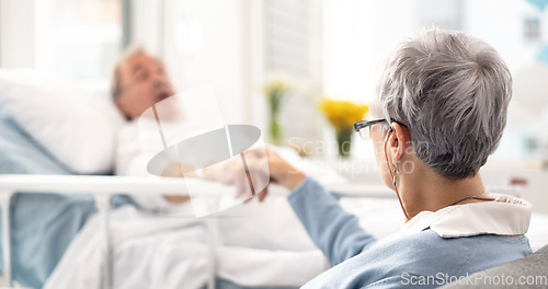 Image of Hospital, bed and senior couple holding hands, empathy and chat about recovery support, medical problem or rehabilitation. Retirement, clinic bedroom and elderly woman talking to sick cancer patient