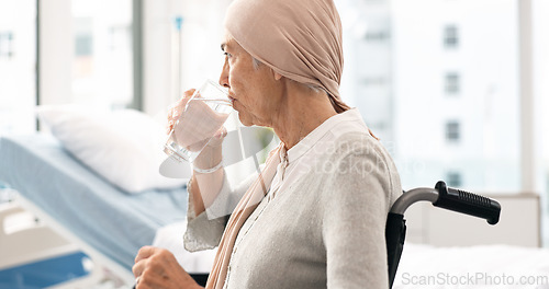 Image of Cancer, Parkinson and elderly woman at hospital in wheelchair with water after chemotherapy or treatment. Health, elderly care and female patient with disability, sickness or disease and depression