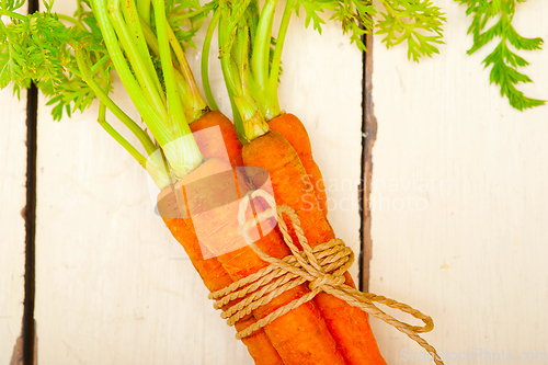 Image of baby carrots bunch tied with rope