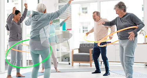 Image of Fitness, senior and people with hula hoop at the gym for training, workout and health in retirement. Happy, together and a group of elderly friends with a coach and gear for an exercise class