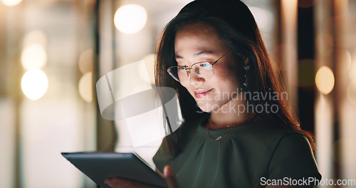 Image of Corporate woman, reading tablet and night with smile, focus and happy for email communication, chat or app. Asian executive, social media marketing and working in night on web, tech or social network