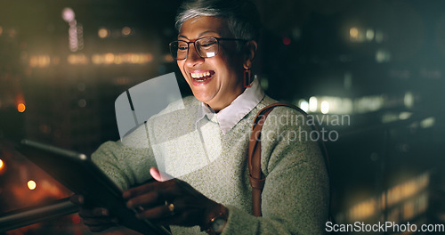 Image of Night, tablet and business woman laughing at comic meme or joke after finishing project. Social media, mature and happy female employee typing on touchscreen after working late in dark workplace.