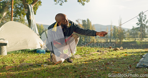 Image of Camping, tent in ground and black man setup in nature for shelter on outdoor holiday, vacation and adventure, Campsite, travel and male person with hammer for gear in woods, forest and countryside
