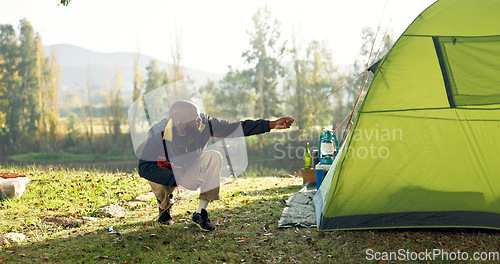 Image of Camping, tent and black man setup in nature for shelter on outdoor holiday, vacation and adventure, Campsite, traveling and male person with hammer for pins for gear in woods, forest and countryside