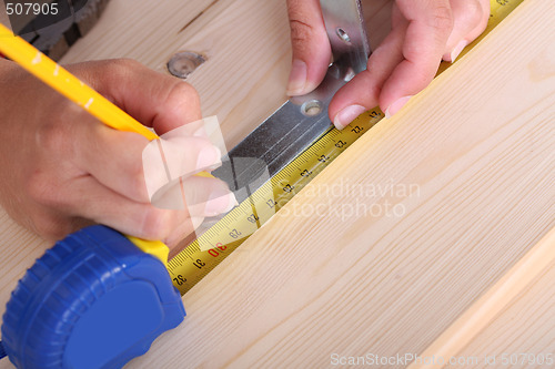 Image of wooden plank and measuring tape 