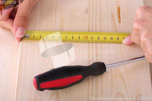 Image of wooden plank and measuring tape 