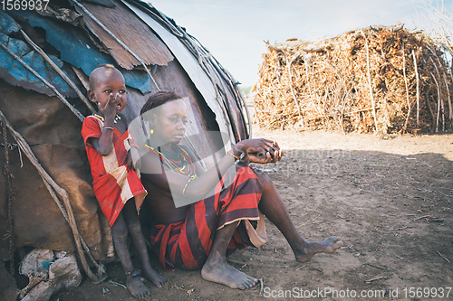 Image of Dasanesh woman with child in Omorate, Omo Valley, Ethiopia