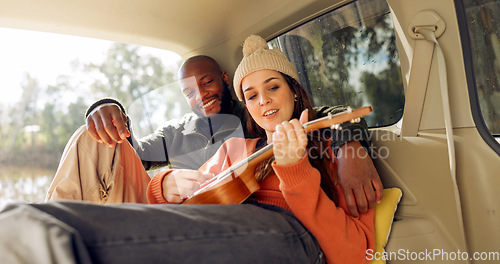 Image of Singing with Guitar, winter and a couple in a car for a road trip, date or watching the view together. Happy, travel and back of a man and woman with an affection in transport during a holiday or cam