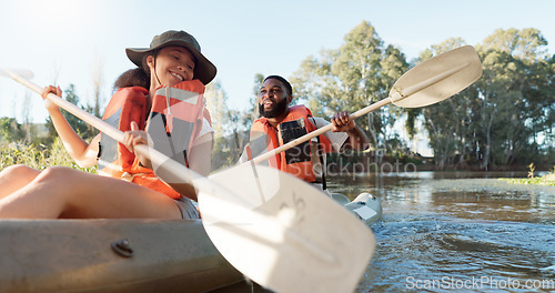 Image of Couple, kayak and rowing on a lake in nature for sports challenge, adventure or travel with a smile. Young man and woman friends together on boat and water for fitness, travel and holiday for freedom