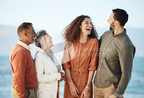 Image of Funny, happy and travel with big family at beach for summer vacation, care and support. Love, smile and happiness with senior parents and couple laughing in nature for holiday, relax and bonding