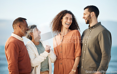 Image of Funny, summer and travel with big family at beach for vacation, care and support. Love, smile and happiness with senior parents and couple laughing in nature for holiday, relax and bonding together