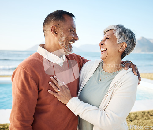 Image of Beach, laughing and happy senior couple on vacation or holiday together with love in nature at the sea or ocean. Elderly, man and woman relax with happiness, care and smile on retirement bonding
